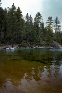 Rainbow-hued waters of Lake Tahoe, looking north, from a secluded cove on the Rubicon Trail. View just outside of Emerald Bay.