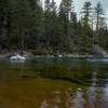 Rainbow-hued waters of Lake Tahoe, looking north, from a secluded cove on the Rubicon Trail. View just outside of Emerald Bay.