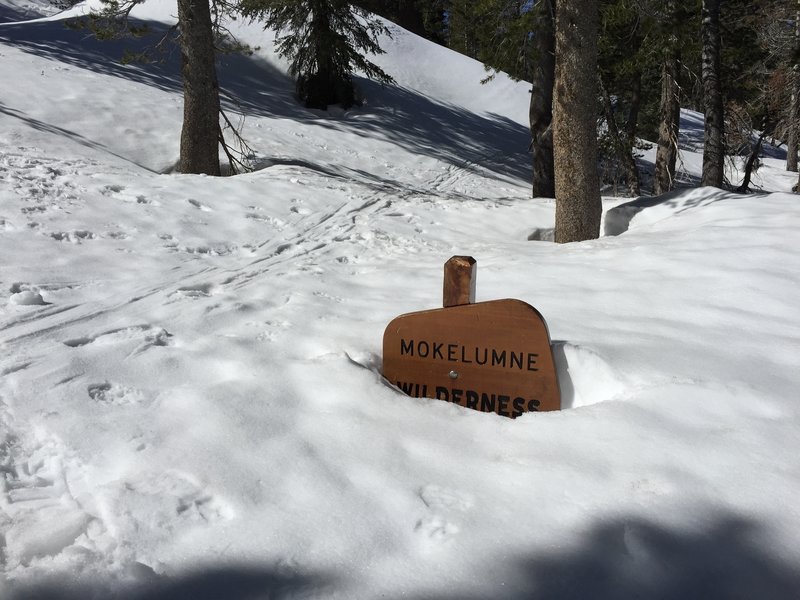 Late April snow nearly buried the sign at the beginning of the trail.