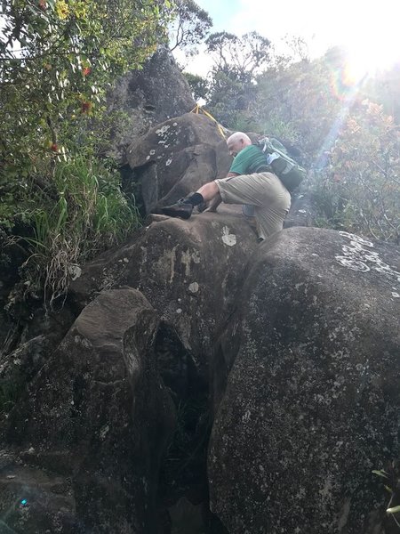 Climbing up the huge rocks using rope