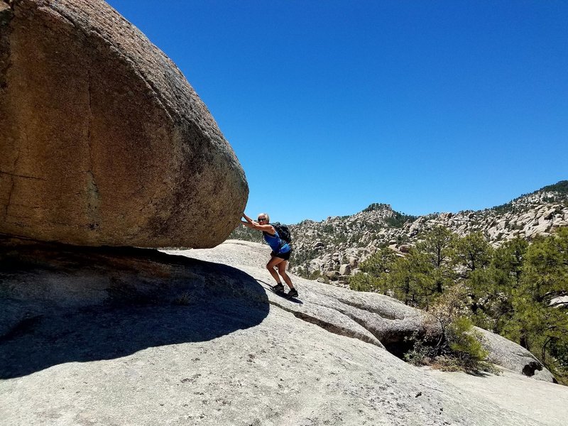 Rock formations near upper pools. Sandie pushing the rock.