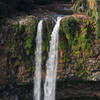 Chamarel Falls plunging over a cliff covered in lush vegetation.