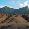 A small mountain offers a lovely backdrop to the seven coloured earths