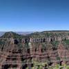 A short ways from the south of Bright Angel and Transept Trail. Just left of center is Oza Butte. Transept Gorge below. What looks like a ridge is a square peninsula that includes the Widforss hike.