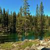 The blue-green waters of a small unnamed lake along Bear Lakes Trail.