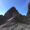 Climbing down boulders on the beach.