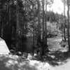 Small off trail wood bench overlooks a wide path of moving water, perfect spot for a lunch break.