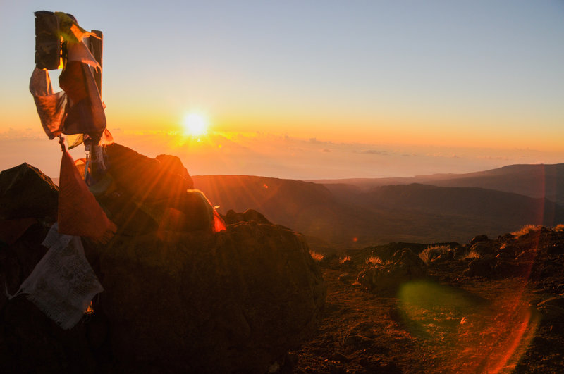 The sun peaks above the clouds over the Indian Ocean as seen from the summit of Piton des Neiges