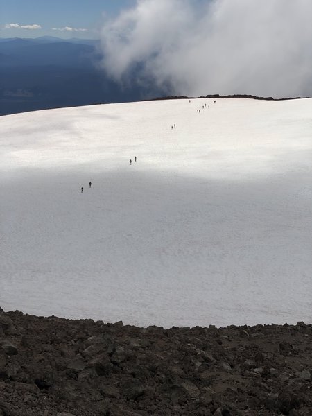 Hikers crossing the crater snowfield