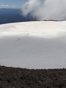 Hikers crossing the crater snowfield