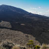 Newer lava flows are clearly visible as darker black rock.