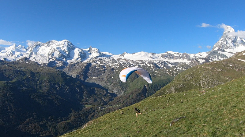 A common paraglider launch from the grassy hillside