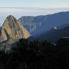 Early morning sun beams stream down from Roche Ecrite into Cirque de Mafate.