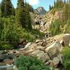 A creek tumbles down a waterfall to flow into Four Point Creek. Several of these side creeks get rock hopped or splashed through on the Jonas Pass Trail.