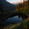 Early morning by Lake Josephine on the Upper Grinnell Lake Trail. Mount Gould illuminated in the distant background.