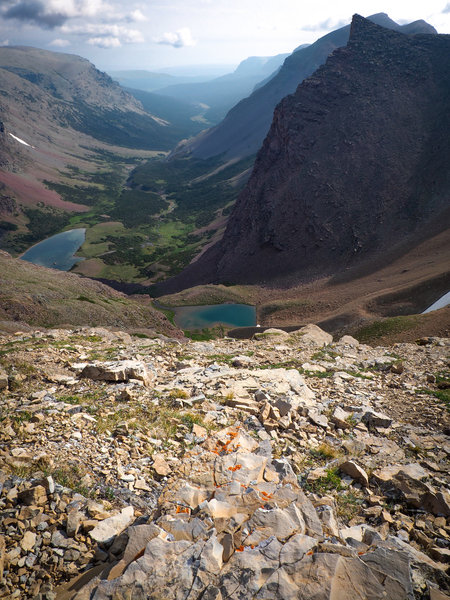 Looking out from Siyeh Pass into Boulder Creek Valley. Unnamed lakes (middle, left center) feed the creek which winds down into Saint Mary Lake.