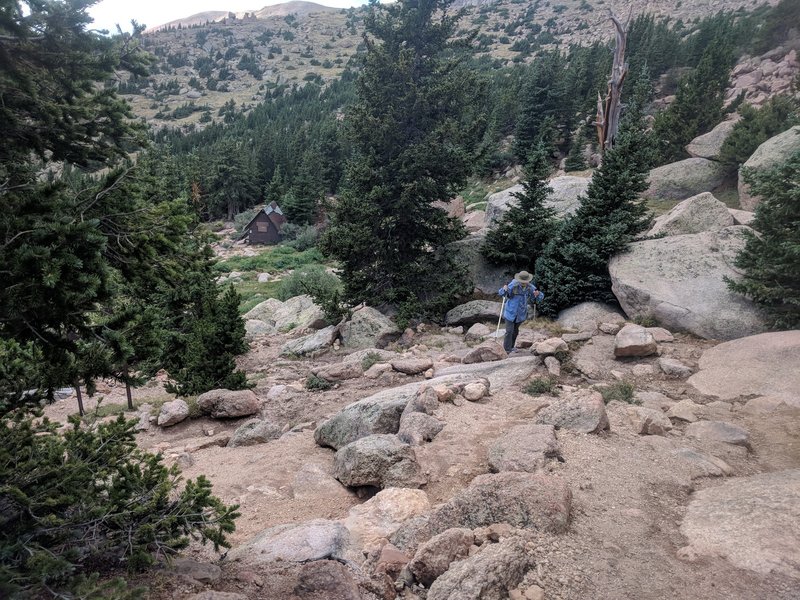 Be careful here, it is easy to lose the trail just past the A-frame. The trail is up and to the right as you head up (we are off the trail here).  It looks like you should go up over the broken rocks, but if you go to the right, you'll find the trail