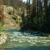 The beautiful turquoise Miette River is crossed by the Dorothy, Christine and Virl Lakes Trail on a sturdy bridge.