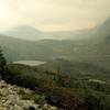 Coleman Gacier is seen in the distance from the morraine at the end of Coleman Glacier Trail on a hazy, overcast day. Yates Torrent is the glacial creek carrying melt water to the little lake and then down into Smoky River.