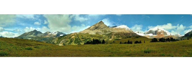 WOW! View from Moose Pass looking west-southwest (left) to north-northeast (right), about 120 degrees. Moose Pass is a long pass in mountain meadows, The trail comes up from the hidden peaks at the left. Center is the end of Calumet Ridge.