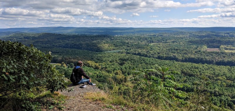 Contemplating the meaning of life (or perhaps it is just thinking on a great breakfast sandwich) along Cliff Trail.