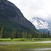 Mirror Pond sits at the foot of the Citadel Mountain. Blackfoot Mountain sits in the background, home to Blackfoot Glacier.