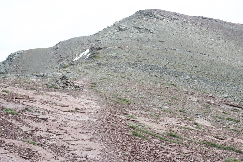 The trail is marked by cairns as it climbs up the side of the mountain.