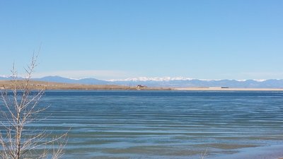 Looking across Aurora Reservoir toward the snow-capped summits of the James Peaks Wilderness.