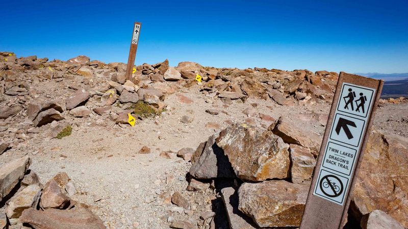 Near the top, cross over the downhill mountain biking trail and follow the ridge to the first summit.