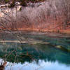 On the Ha Ha Tonka Spring Trail, winter time, looking northwest, across the spring pool at cliffs below the "castle." About:  37.973956, -92.768286