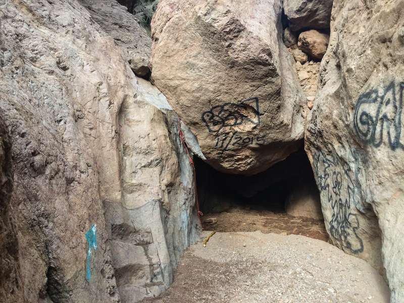 the arrow, steps carved into the rock and the red rope is very useful