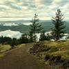 San Juan Islands and the southern tip of Vancouver Island in the far distance, looking south-southwest when approaching the West Overlook on South Trail.