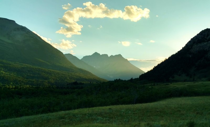 The sun sets behind the mountains to the west, as seen from the prairie along Horseshoe Basin Trail.