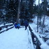 Walking through the snow looking at frozen creek.