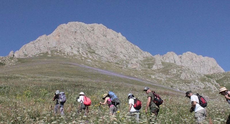 The hikers on the way to peak of Mount Khustup