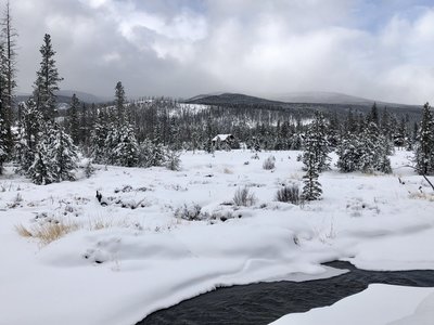 View of the Rocky Mountains and a nearby cabin