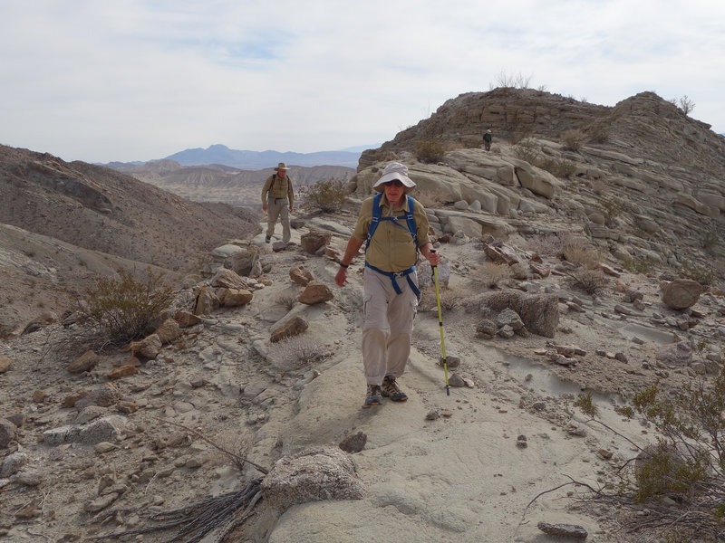 Hikers descending a spot elevation on the Split Mountain Loop