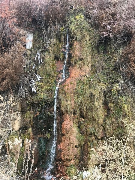 Skinny waterfall with interesting mineral deposits on the rocks.