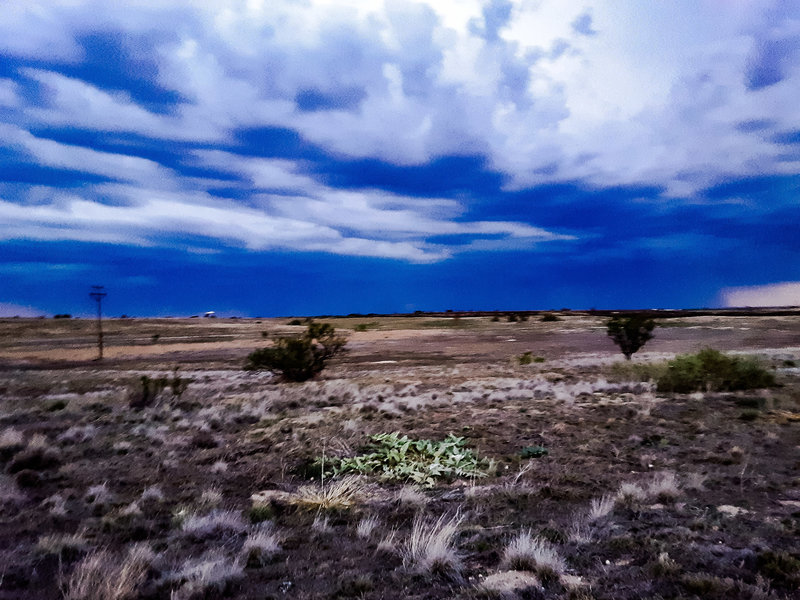 "Night hike" looking north up Yellowhouse Draw over area of controlled burn to thunderstorms 10 miles distant.