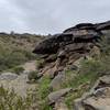 On the back side of this formation, the wash has carved a shallow cave into the rock. You'll see it coming down from the JC trail peak.