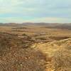 With an Elk Mountain shoulder to the left, Elk Mountain Trail heads northwest with views of Caddo Lake, the prairie, and Wichita Mountains.