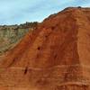 The various colors of the canyon wall layers up close, at the base of Fortress Cliffs on Comanche Trail North.