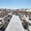 The wheelchair accessible Interdune Boardwalk surrounded by mounds of white gypsum sand.