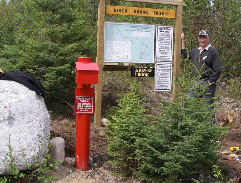 Trailhead for summer hiking with red collection box