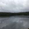 Cloudy, mountain view behind lake