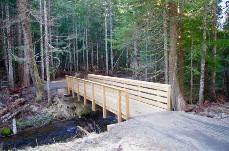 The first 1/4 mile of Mirror Lake Trail to the new bridge over Camp Creek is paved and barrier free.  A total of ten new bridges were flown in by helicopter on the relocated trail.  Photo by Knud Martin, Federal Lands Highway Division