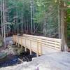 The first 1/4 mile of Mirror Lake Trail to the new bridge over Camp Creek is paved and barrier free.  A total of ten new bridges were flown in by helicopter on the relocated trail.  Photo by Knud Martin, Federal Lands Highway Division