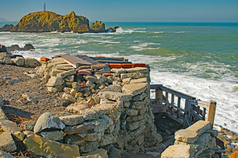 Unusual rock shelter with a wood frame inside and two small wooden benches