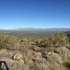 View back (north) to the trailhead from the saddle.