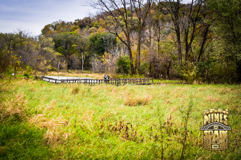 Runners crossing a bridge on the Sauk Fox trail during the 2018 Mines of Spain 100